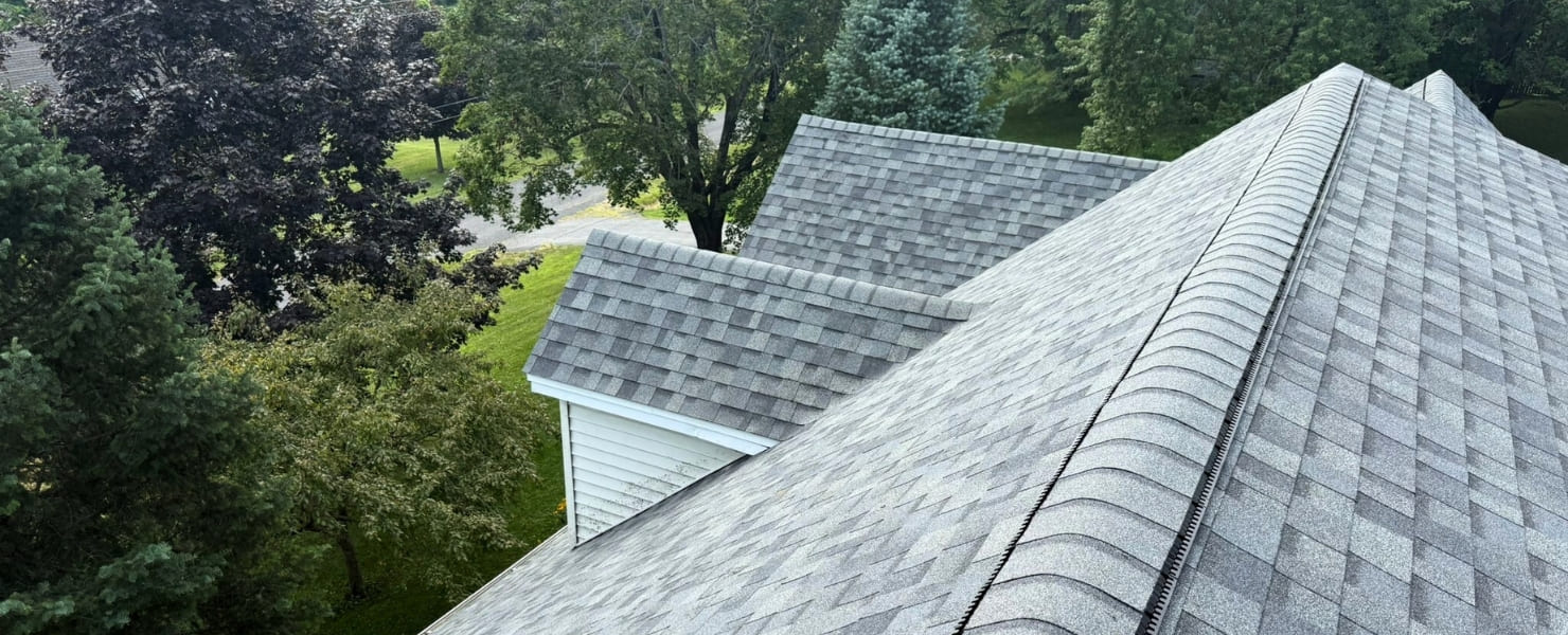 High-quality architectural asphalt shingle roof installation in Albany, NY, featuring a professional ridge vent system for optimal home ventilation and protection