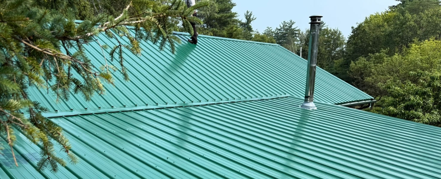 Professional installation of a durable green standing seam metal roof in the Capital District, showcasing precision finishing and weatherproofing by MG Contractor NY
