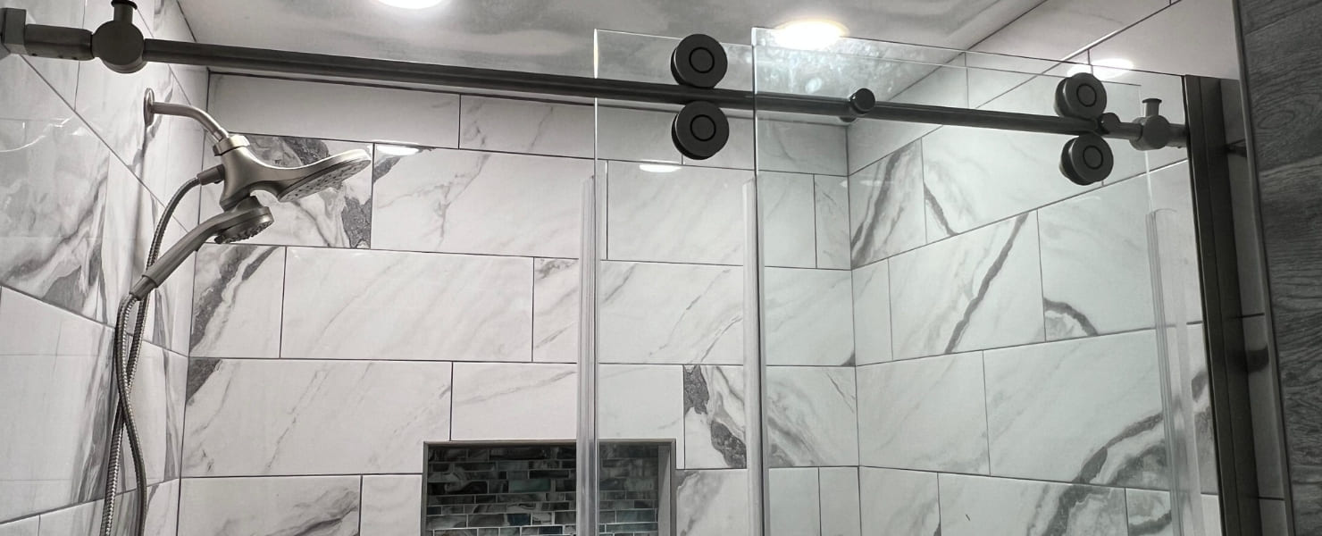 View of a finished custom gray and white tiled bathroom as part of a contractor portfolio gallery showcasing multiple home renovation projects